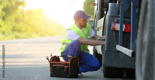 Male driver fixing big truc...