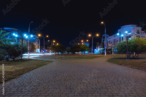 View of city park with street lights at night © Pixel-Shot