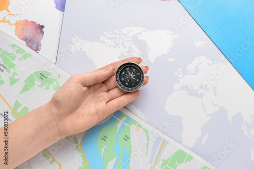Female hand with compass on...