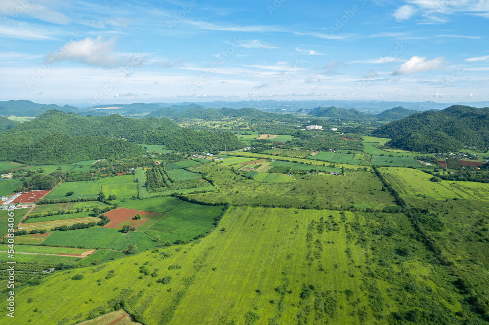 top view farm with mountain background, Aerial view from flying drone of farm, landscape nature blue sky and hill