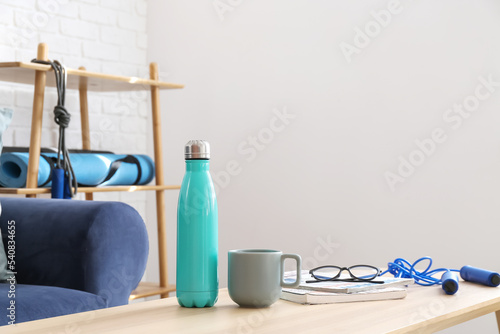 Bottle of water, cup, eyegl...
