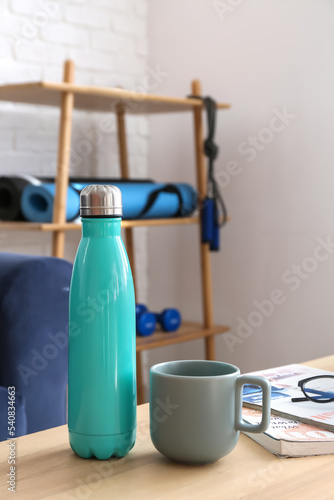 Bottle of water and cup on ...