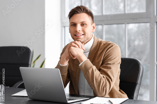 Smiling businessman working...