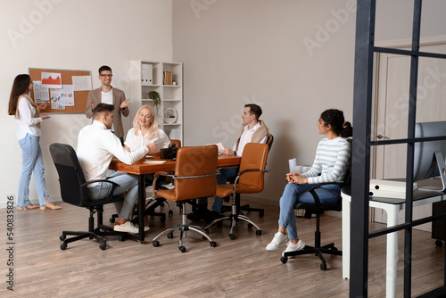 Business co-workers giving presentation during meeting in office