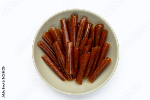 Dried mango paste sheets on white background.