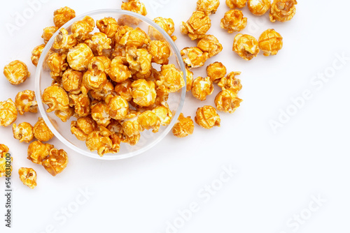 Honey caramel popcorn on white background.