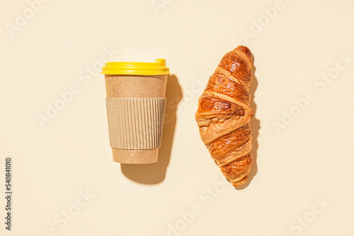 Paper cup and tasty croissa...