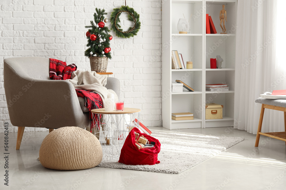 Obraz premium Stylish interior of living room with Santa bag and gifts