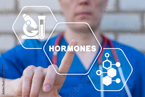 Doctor using virtual touchscreen presses word: HORMONES. Concept of hormone balance. Hormonal therapy. Hormones treatment medical innovation. photo