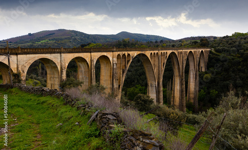Impressive view of old railway bridge Viaduct of Guadalupe, Spain, at cloudy spring day