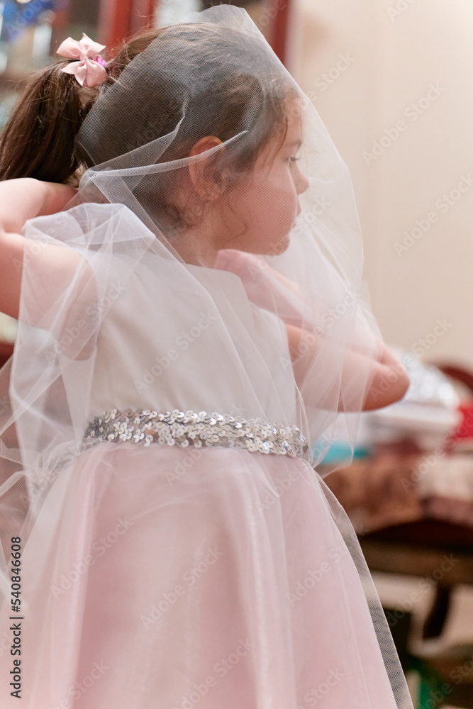 beutiful young girl playing with a gauze formal dress