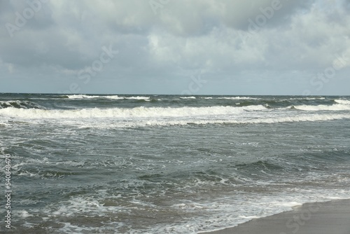 Picturesque view of wavy sea on cloudy day