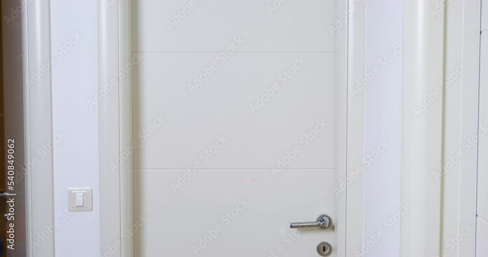 Childish young man walks down corridor, stops in doorway, turns around to make an offended grimace, and then enters the room slamming the door, view from the back Childish young man walks down corridor, stops in doorway, turns around to make an offended grimace, and then enters the room slamming the door, view from the back