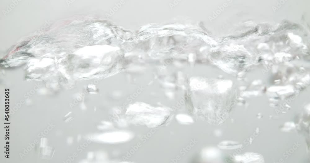 Slow motion of boiling water on a white background. Slow motion of boiling water on a white background.