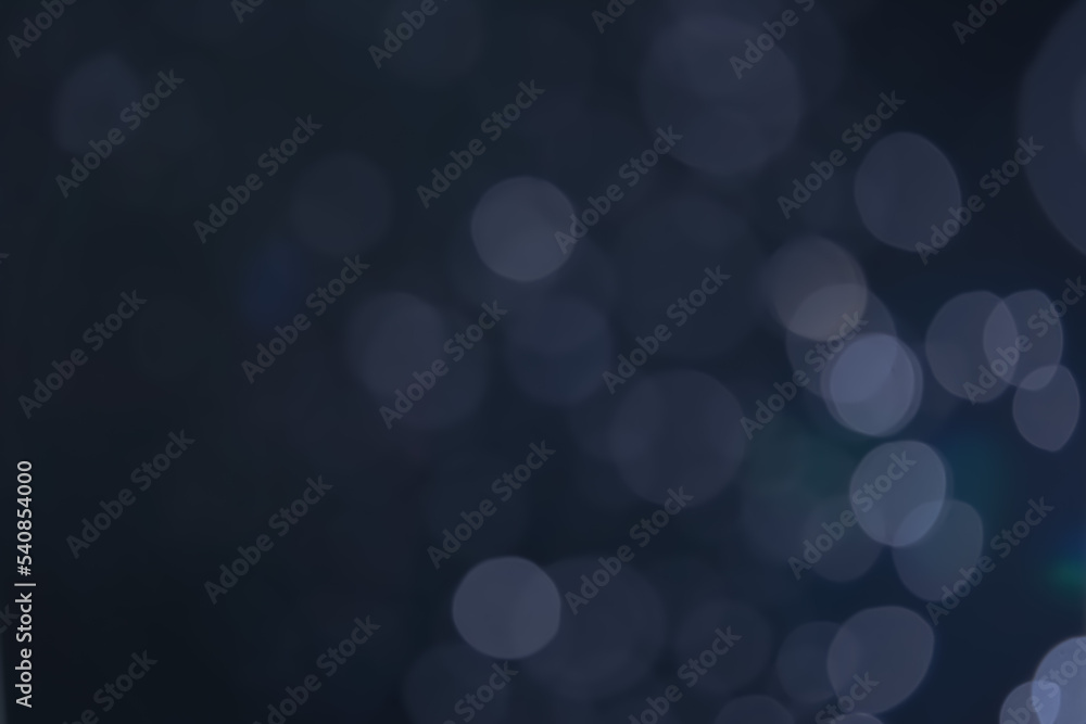 A dark blue background bokeh image for used to decorate background. A dark blue background bokeh image for used to decorate background.