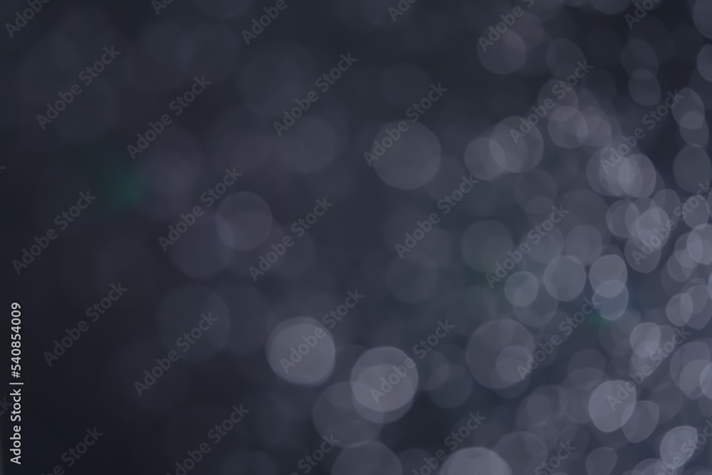 A dark blue background bokeh image for used to decorate background. A dark blue background bokeh image for used to decorate background.