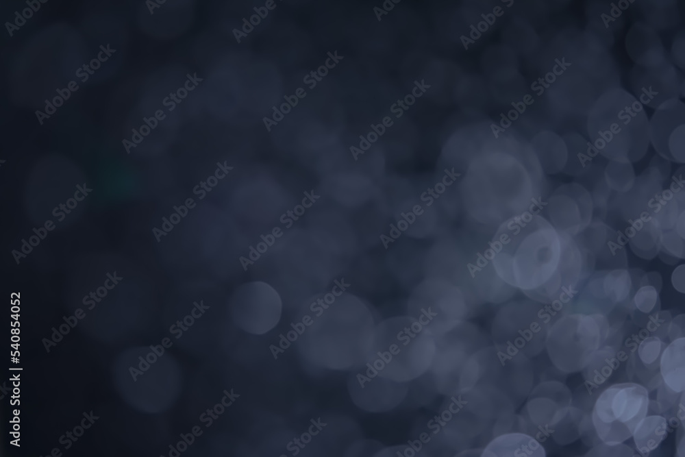A dark blue background bokeh image for used to decorate background. A dark blue background bokeh image for used to decorate background.