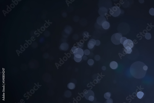 A dark blue background bokeh image for used to decorate background.