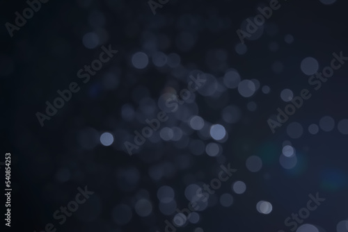 A dark blue background bokeh image for used to decorate background.