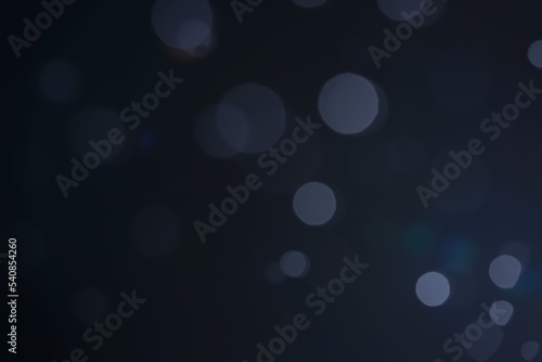 A dark blue background bokeh image for used to decorate background.