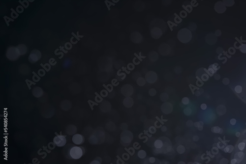 A dark blue background bokeh image for used to decorate background.