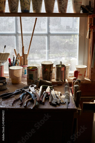 Tools in wood shop studio. Artist studio, carpenter. Beautiful window light. Art supplies.