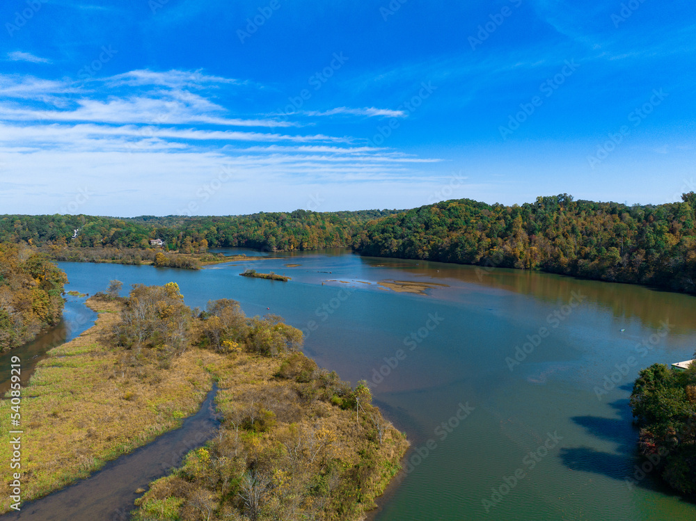 Morgan Fall Overlook Park on sunny Fall day.  Aerial river view with Fall and Autumn colored trees. Drone shot