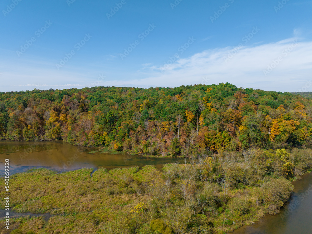 Morgan Fall Overlook Park on sunny Fall day.  Aerial river view with Fall and Autumn colored trees. Shot in 4K