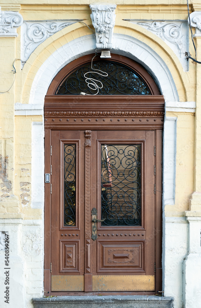 Ornate wooden door of old building in Kyiv, Ukraine Ornate wooden door of old building in Kyiv, Ukraine