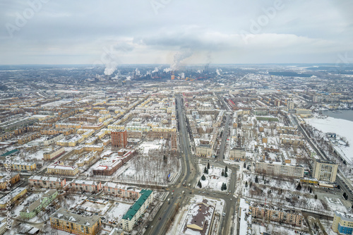 Winter view of the center of the city of Nizhny Tagil and the metallurgical plant from above. Environmental problem of environmental pollution and air in large cities