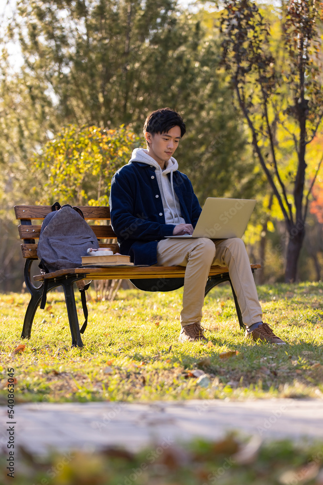 Happy college student using laptop on campus Happy college student using laptop on campus