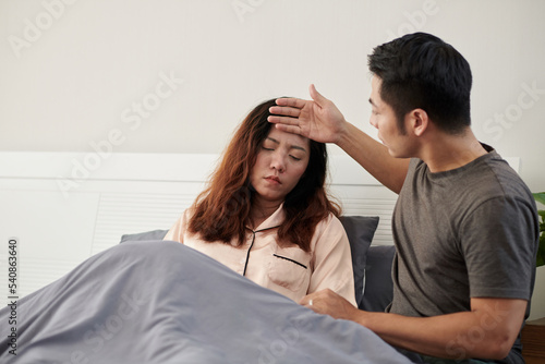 Husband Touching Forehead of Sick Wife