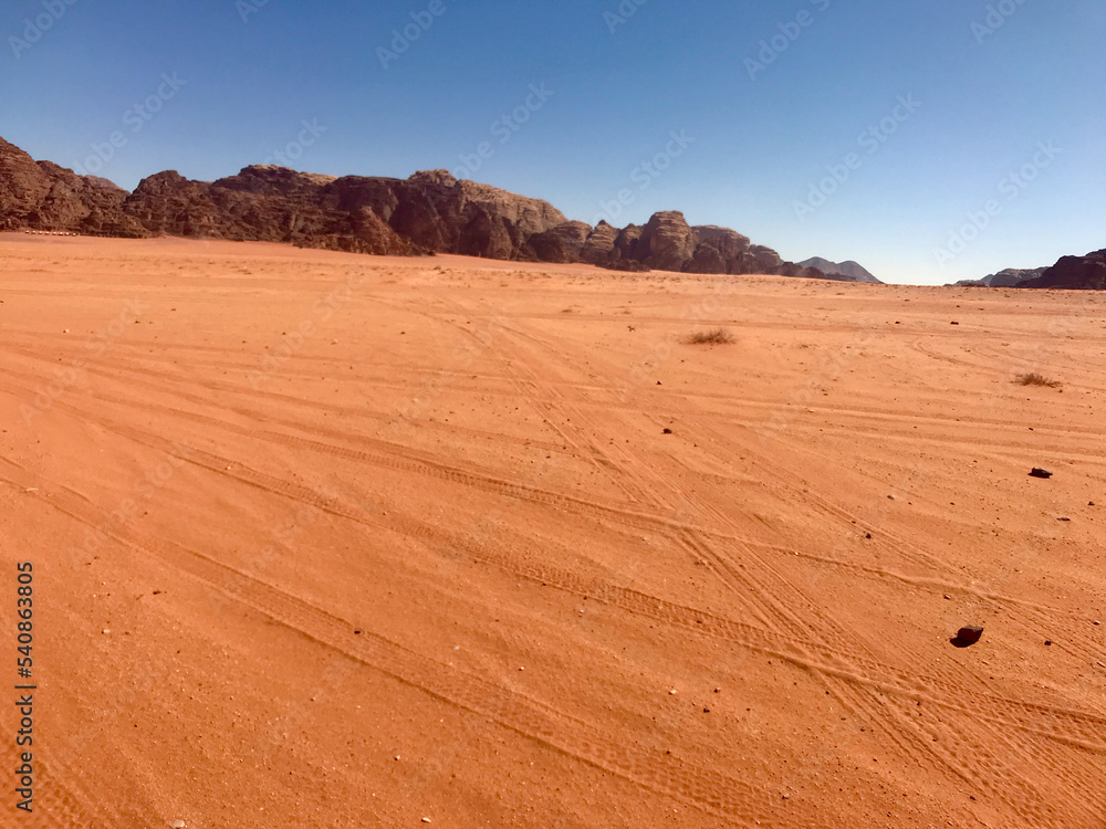 Fototapeta premium Wadi Rum, Jordan, November 2019 - The desert is on the side of a dirt field