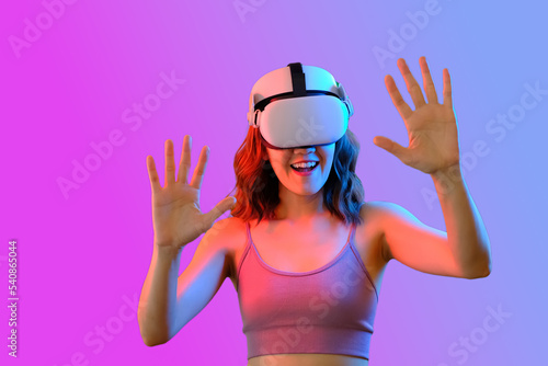 women using Virtual reality to connecting internet. futuristic concept and new technology. purple and blue gradient neon background . selective focus 