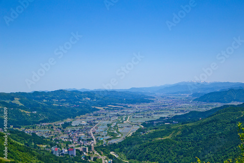 Fototapeta Naklejka Na Ścianę i Meble -  Scene of Echigo Yuzawa city and mountain ranges in summer, views from Yuzawa Kogen.