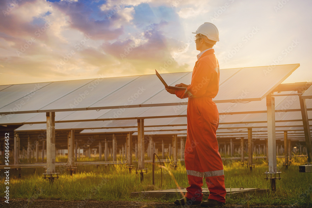 Silhouette of Electrical, instrument technician working with smart pad, maintenance electric system at sunset solar panel field. Silhouette of Electrical, instrument technician working with smart pad, maintenance electric system at sunset solar panel field.