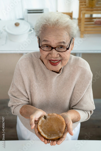 Grandma holding tea mushrooms or kombucha tea, Scoby, healthy fermented food, Probiotic nutrition drink for good health, view from above