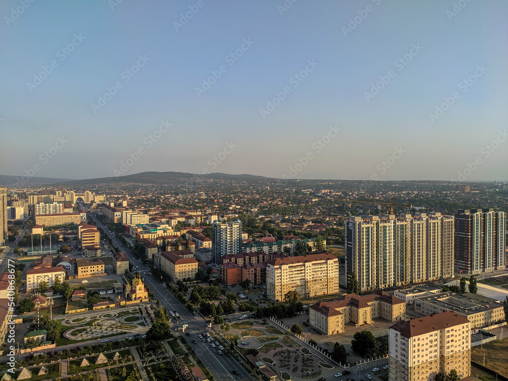 Grozny, Chechnya, Russia - August 17, 2022: View of the city landscape and mountains on the horizon from the roof of the Grozny City business center