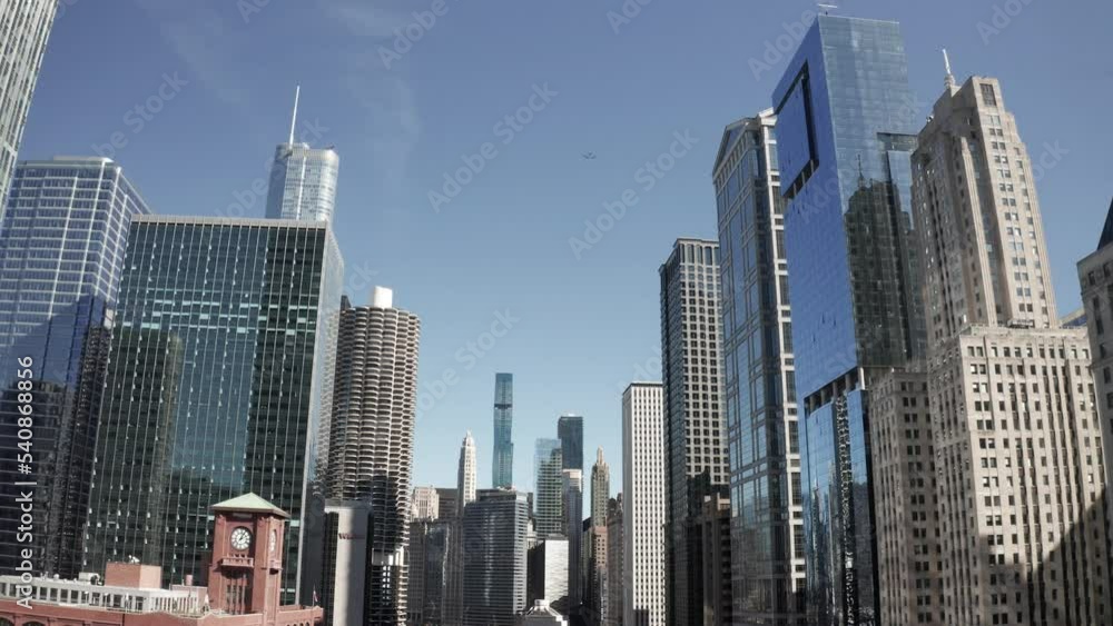 Downtown Chicago, Illinois with tall buildings and drone video moving forward at an angle. Downtown Chicago, Illinois with tall buildings and drone video moving forward at an angle.