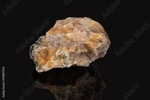 The mineral andalusite is brownish in color with white veins.