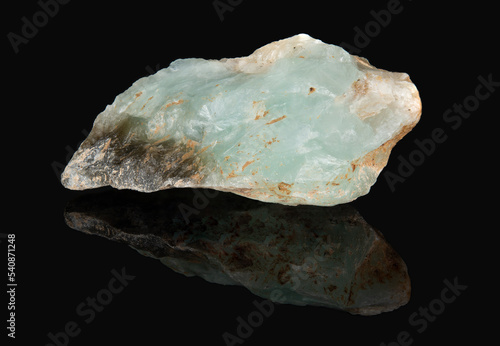 A raw shard of the mineral prehnite. A translucent greenish stone photo