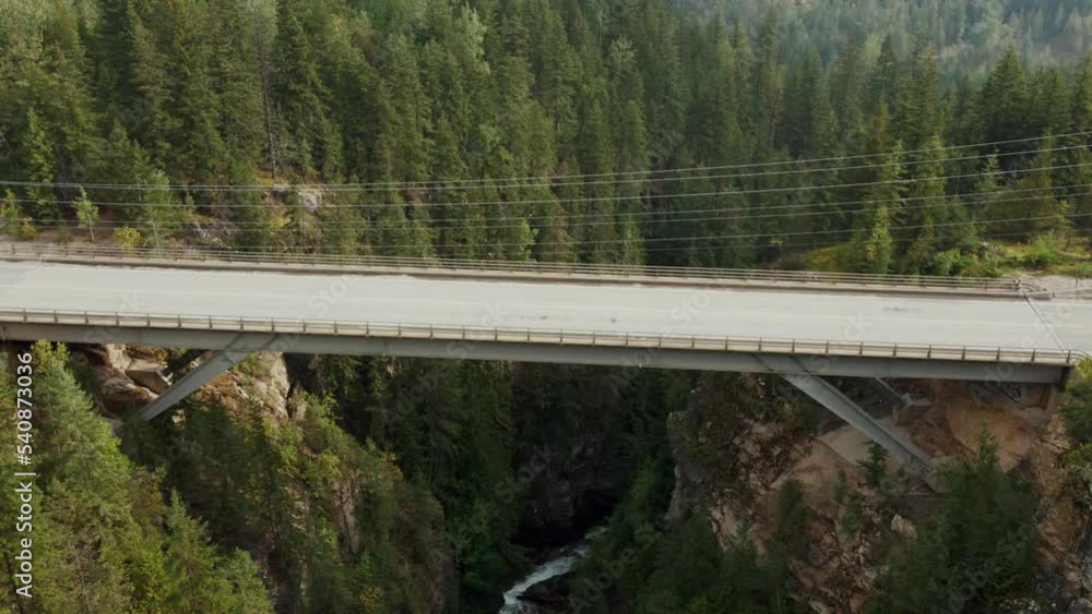 Slow aerial dolly with a car passing over the canyon bridge Slow aerial dolly with a car passing over the canyon bridge