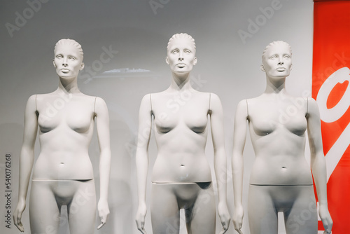 Naked mannequins in the window of a clothing store. Sale and discount concept photo