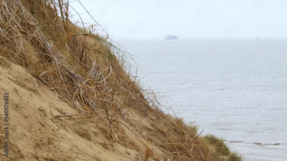 Formby beach, Merseyside coastline beach a ship sails on the horizon Formby beach, Merseyside coastline beach a ship sails on the horizon