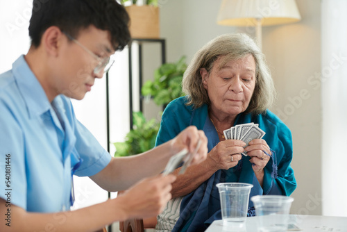 Old Woman Playing Cards with Nurse