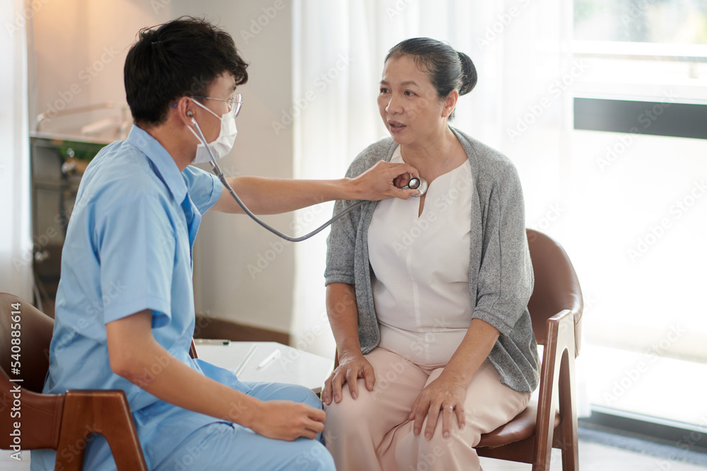 Obraz premium Doctor Listening to Lungs of Patient