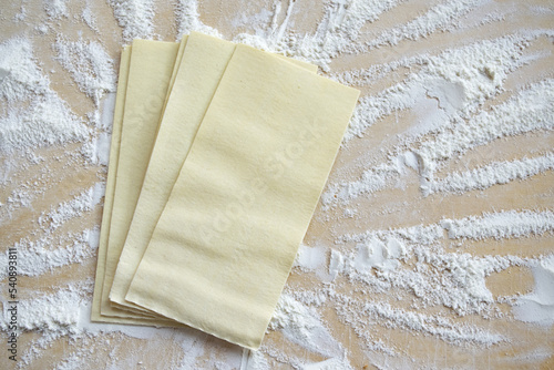 lasagna sheets on a pastry board with flour
