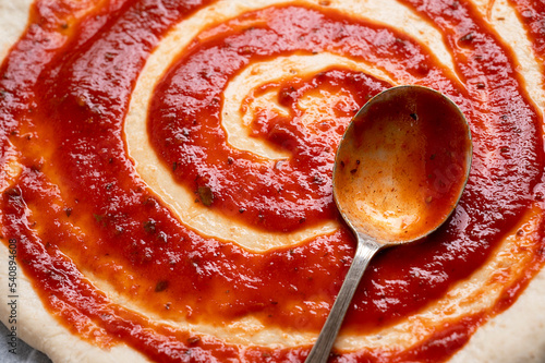 Konstfotografi Cooking pizza, tomatoe sauce on raw dough