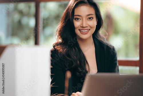 portrait of smile and happy young professional businesswoman, female freelance entrepreneur lifestyle with business work using computer laptop or tablet online cyberspace technology, beautiful woman