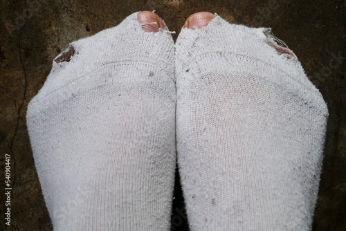 Принти на полотні Man toes poking through holes in white socks, hardship concept